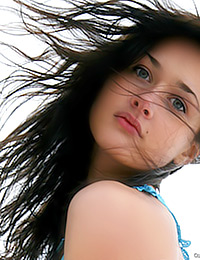 The wind is playing with her long hair and she is playing naked with you